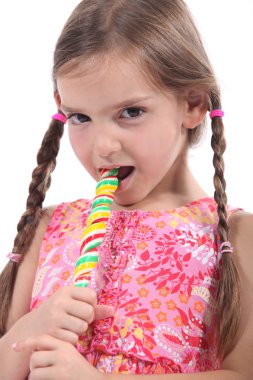 Girl eating a lolly pop clipart