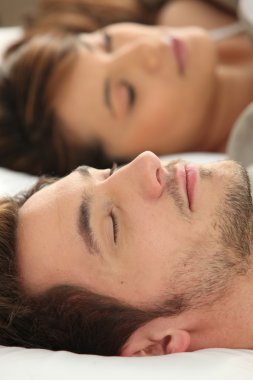 Man and woman sleeping deeply clipart