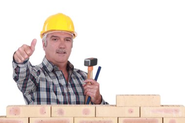 Thumbs up from a bricklayer clipart