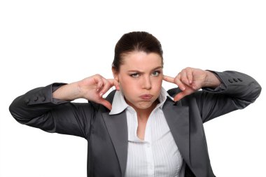 Brunette office worker with fingers in ears clipart