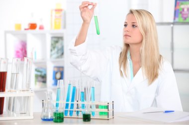 Female chemistry student with a test tube clipart