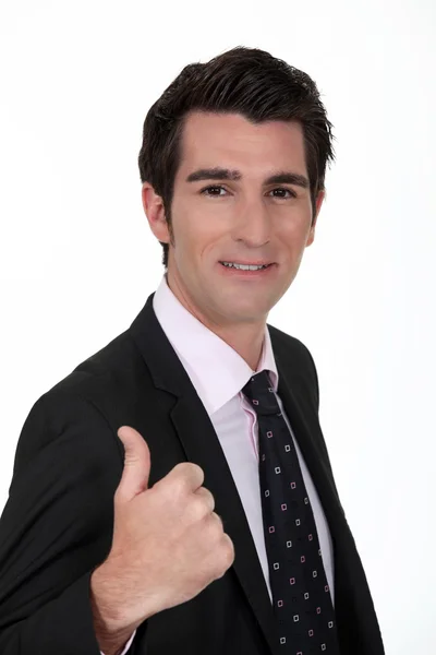 Homem de negócios sorrindo dando o polegar para cima — Fotografia de Stock