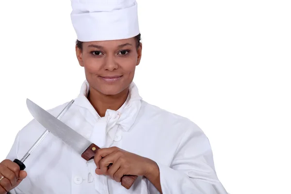 Cook sharpening knife — Stock Photo, Image
