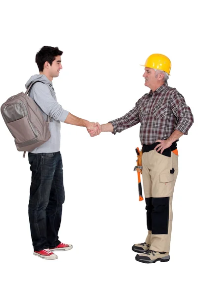 Old and young student worker shaking hands — Stock Photo, Image