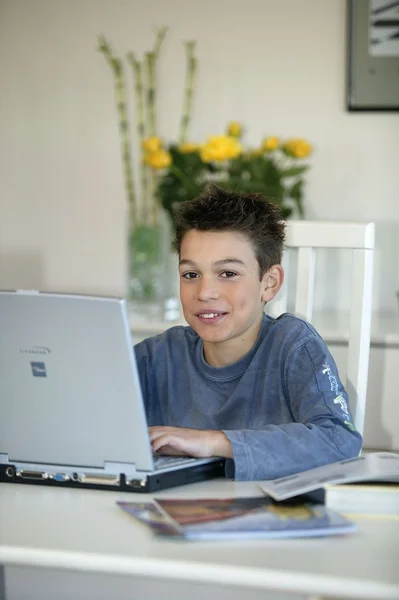 Preteen typing up his homework — Stock Photo, Image