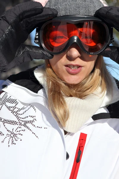 Mujer ajustando sus gafas de esquí — Foto de Stock