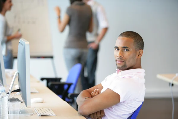 Man sitting back in an office — Stock Photo, Image