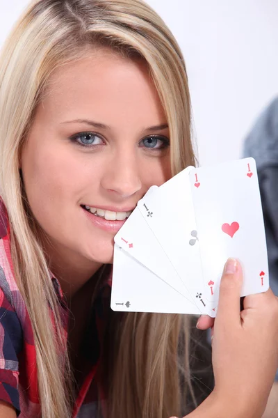Teenage girl holding the winning card hand of four aces — Stock Photo, Image