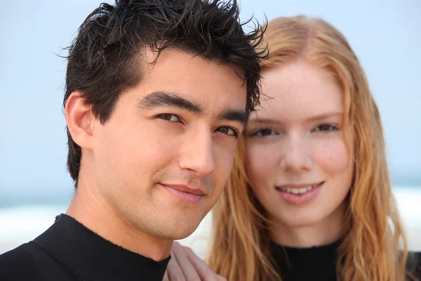 Two teenagers wearing surf suits — Stock Photo, Image