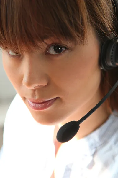 Closeup of a woman wearing a telephone headset — Stock Photo, Image