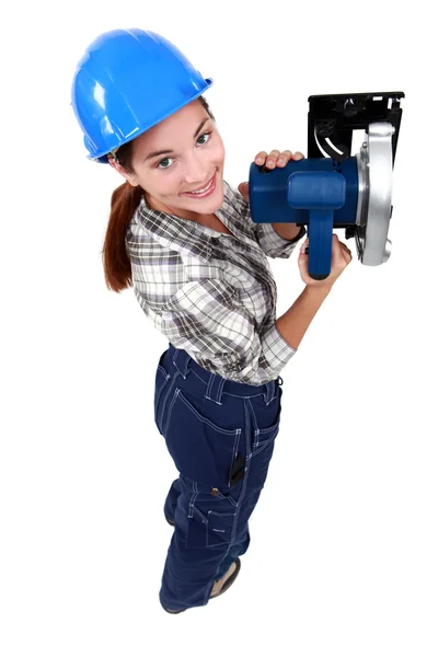 Craftswoman holding an electric saw — Stock Photo, Image