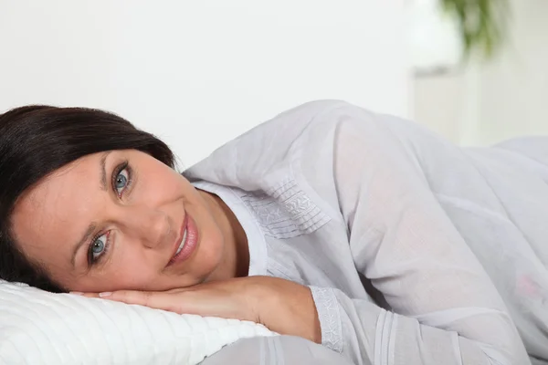 Женщина, лежащая на подушке — стоковое фото