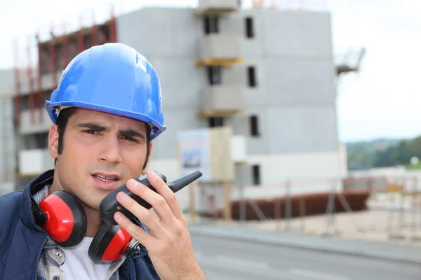 Craftsman talking on a talkie walkie — Stock Photo, Image