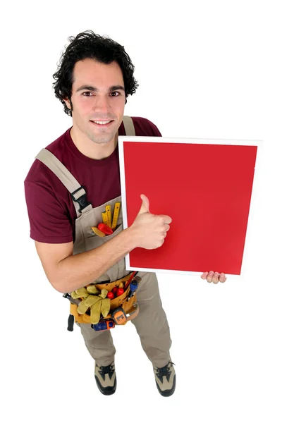 Artigiano che tiene una tavola dipinta di rosso — Foto Stock
