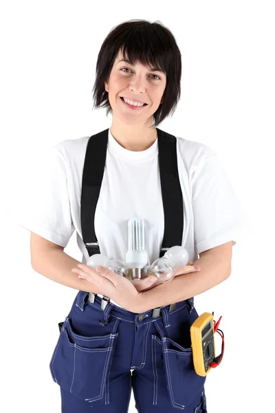 Female electrician holding light bulbs — Stock Photo, Image