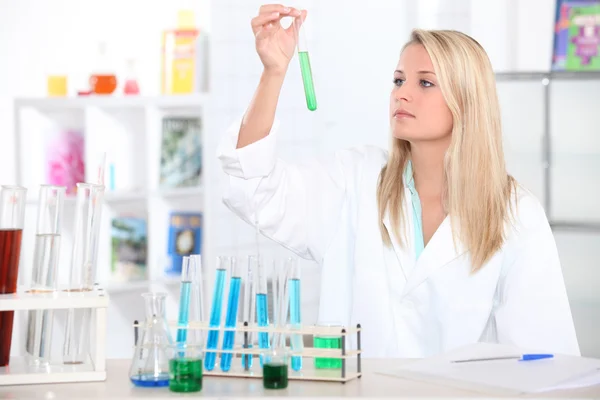Estudiante de química femenina con un tubo de ensayo — Foto de Stock