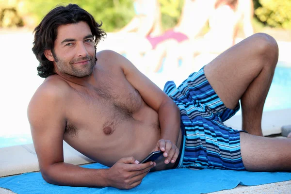 Man on beach towel — Stock Photo, Image