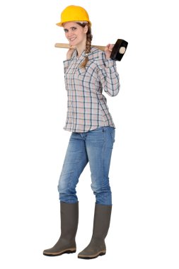 Portrait of young female carpenter holding hammer clipart