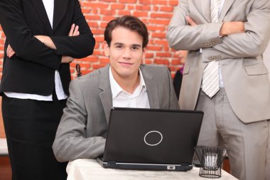 Smart young man at a laptop computer clipart