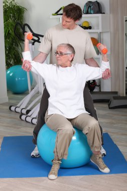 Elderly woman with personal trainer clipart