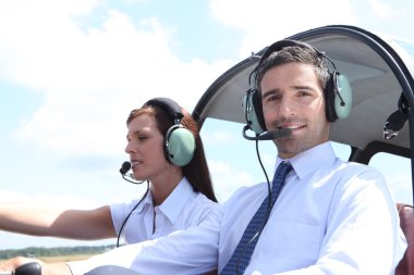 Man and woman in the cockpit of a light aircraft clipart