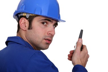 Builder using a walky talky clipart