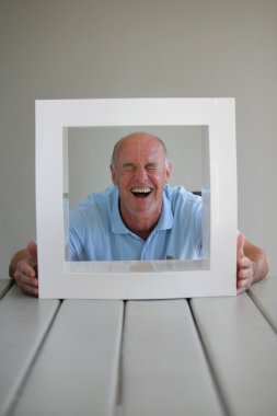 Senior looking through a picture frame clipart