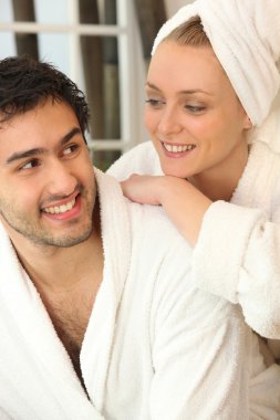 Couple relaxing together after a shower clipart