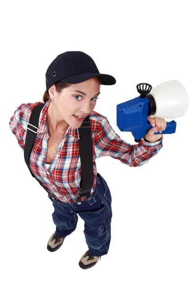 Sexy craftswoman holding a sprayer — Stock Photo, Image