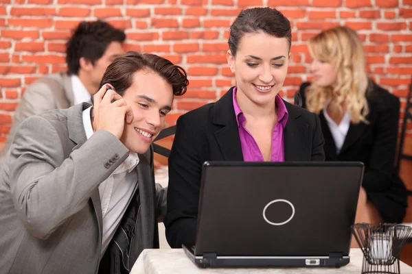 Young co-workers watching laptop — Stock Photo, Image