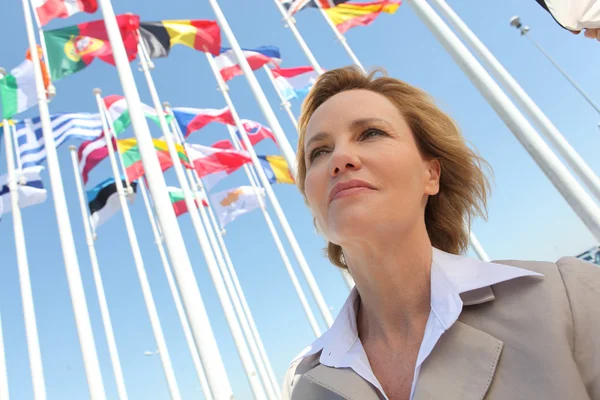 Businesswoman with flags. — Stock Photo, Image