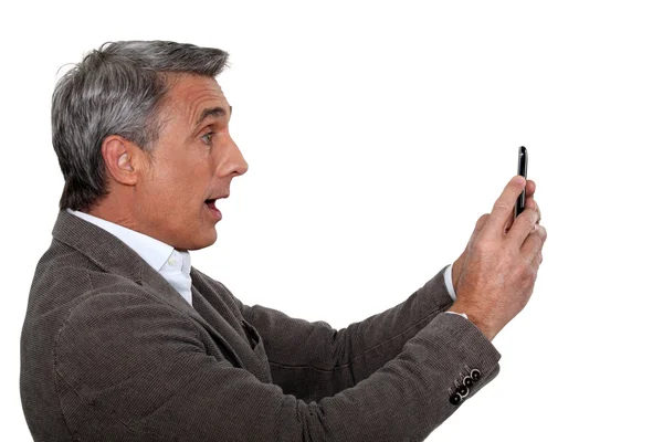 Man caught looking at sms — Stock Photo, Image