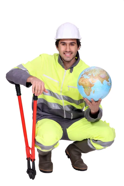 Worker with boltcutters and a globe — Stock Photo, Image