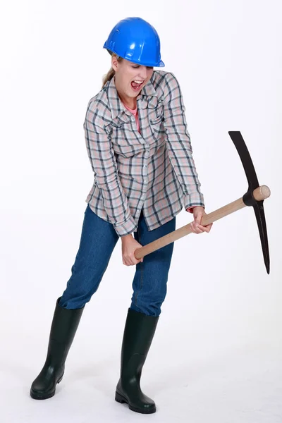 Woman using pick-ax — Stock Photo, Image