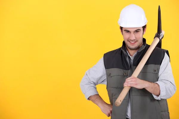 A worker posing with a pickaxe — Stock Image A worker posing with a pickaxe Stock Image