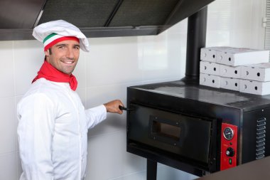 Pizzeria chef next to oven clipart