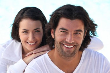 Head and shoulders shot of a well matched couple in white clipart