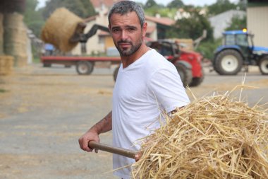 Farmer bailing hay clipart