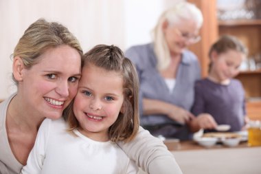 Mother baking with her daughter clipart