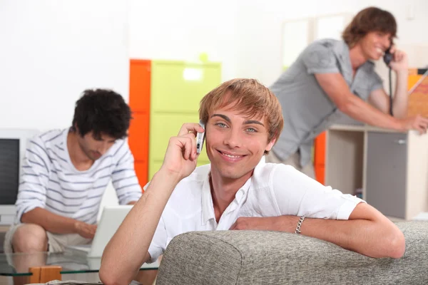 Three smiling lads communicating in different ways — Stock Photo, Image
