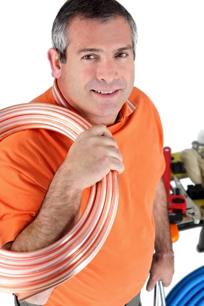 Workers with shoulder roll tube — Stock Photo, Image