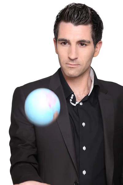 Young man holding a globe — Stock Photo, Image