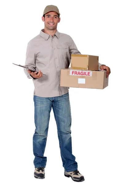 Delivery man standing on white background — Stock Photo, Image