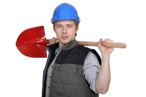 Tradesman holding a spade — Stock Photo, Image