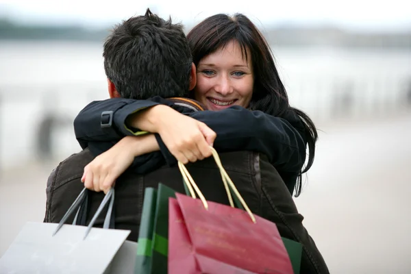 Kvinnan tackar man för presenterar med kram — Stockfoto