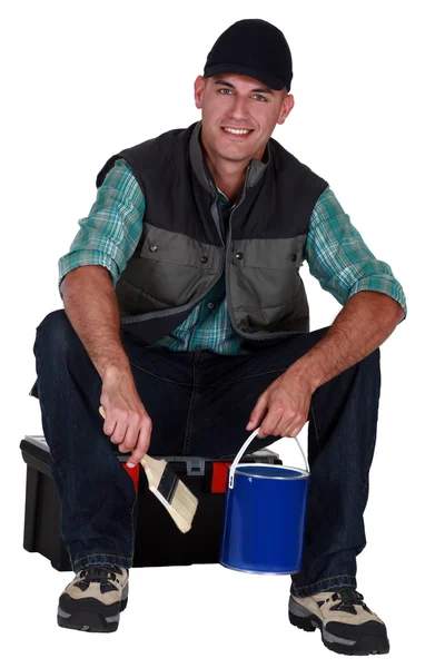 Painter sitting on a toolbox — Stock Photo, Image