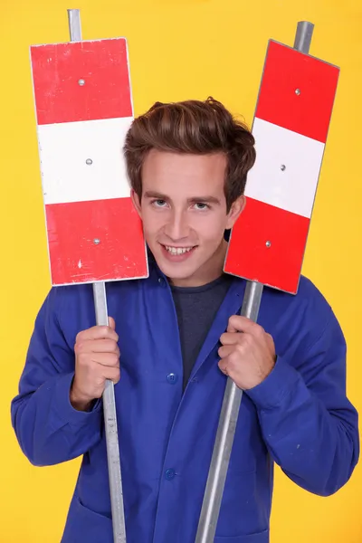 Man holding two metal road signs — Stock Photo, Image