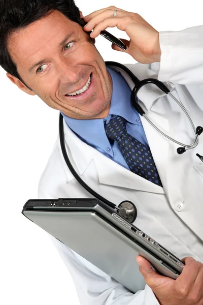Doctor en el teléfono con el ordenador —  Fotos de Stock