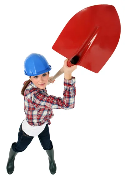 Construction worker wielding a shovel — Stock Photo, Image