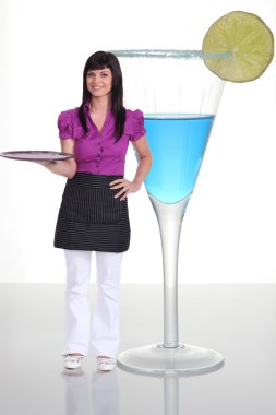 Waitress standing next to a human-sized cocktail clipart